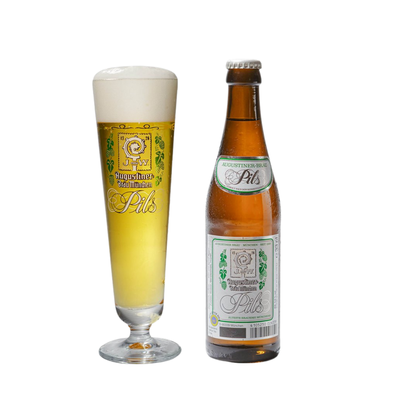 A bottle of Augustiner Pils beer next to a tall stemmed glass filled with the golden beer and frothy head, on a plain white background.