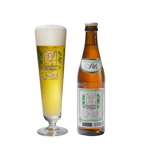 A bottle of Augustiner Pils beer next to a tall stemmed glass filled with the golden beer and frothy head, on a plain white background.